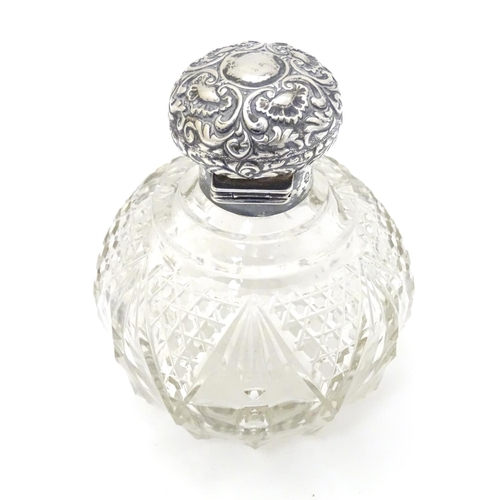 158 - A cut glass scent / perfume bottle with silver top hallmarked Birmingham 1904 4 1/2'' high overall