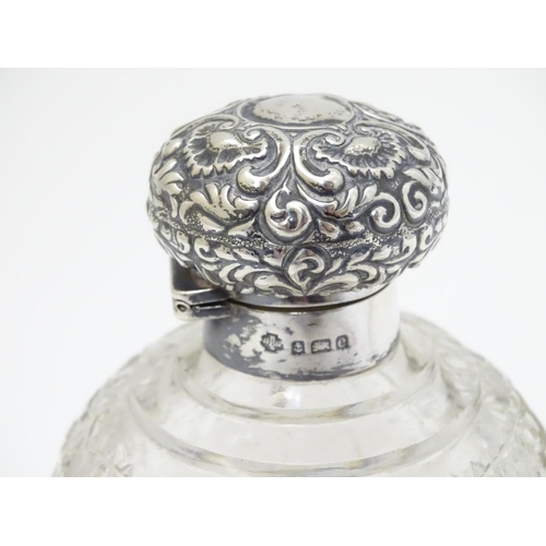 158 - A cut glass scent / perfume bottle with silver top hallmarked Birmingham 1904 4 1/2'' high overall