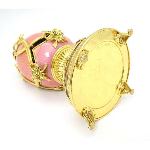 159 - Franklin Mint : A silver gilt model of a Faberge egg ' The Faberge Rose Bouquet ' with pink enamel d... 