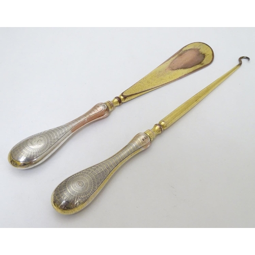 164 - Silver handled button hook and shoe horn with engine turned decoration and traces of gilding. Hallma... 