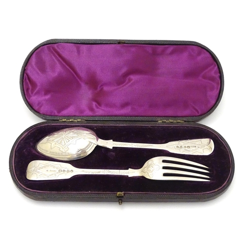 166 - A cased Victorian silver Christening set comprising fork and spoon with engraved decoration. Hallmar... 