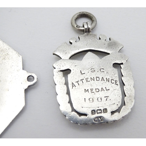 168 - Two silver fobs hallmarked Birmingham 1894 and Birmingham 1907. Together with a medallion depicting ... 