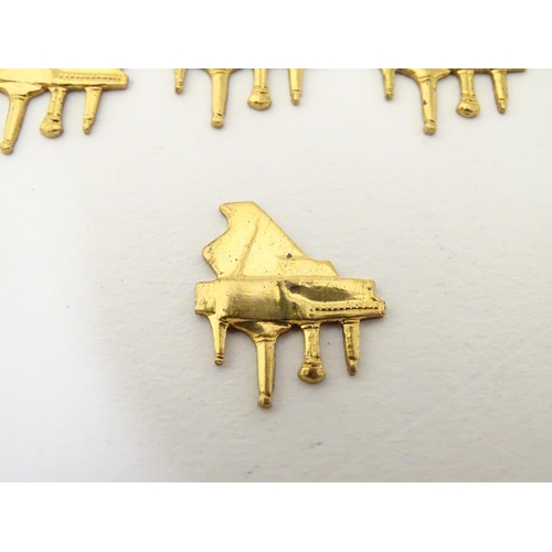 172 - A quantity of gilt metal jewellery findings of grand piano form. Approx 3/4'' wide