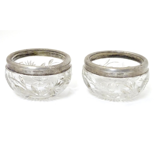 181 - A pair of cut glass salts with silver rims, hallmarked London 1913 maker William Henry Sparrow 2 1/2... 