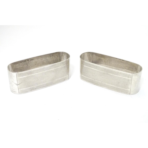 182 - A pair of silver napkin rings with engine turned decoration hallmarked Birmingham 1950 maker John Ro... 