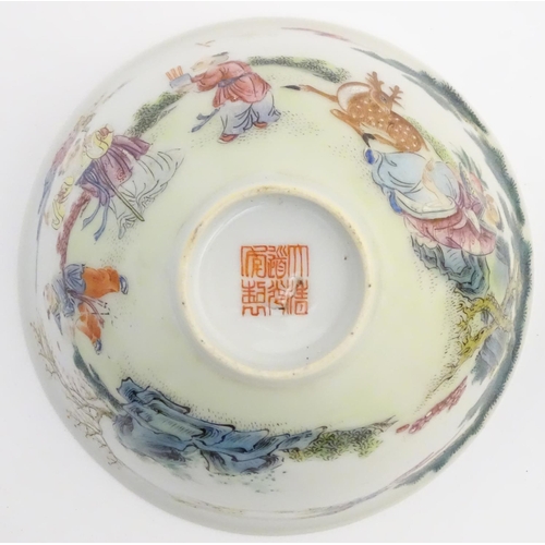 19 - A Chinese famille rose bowl depicting figures and a deer in a landscape. Character marks to base. Ap... 