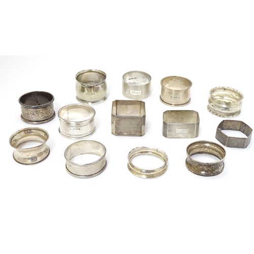 190 - 13 assorted silver napkin rings various dates and makers, some with engine turned deocration, togthe... 