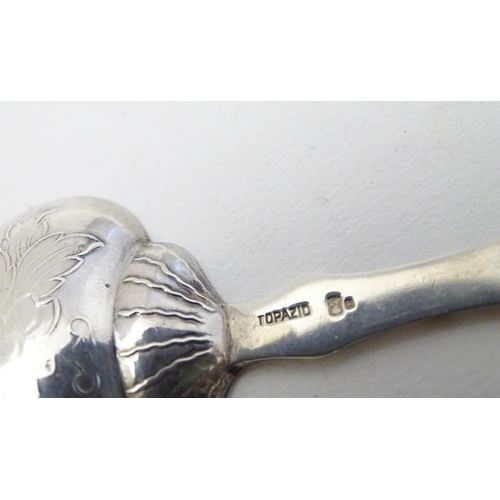 193 - A Portuguese .833 silver tea caddy spoon with engraved decoration and marked Topazio. 3 1/4'' long (... 