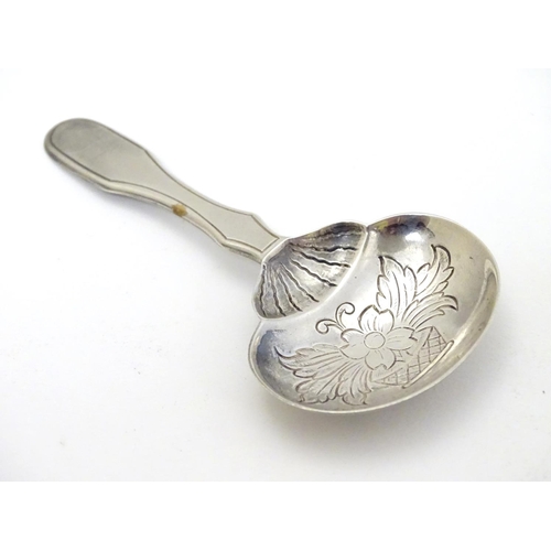 193 - A Portuguese .833 silver tea caddy spoon with engraved decoration and marked Topazio. 3 1/4'' long (... 