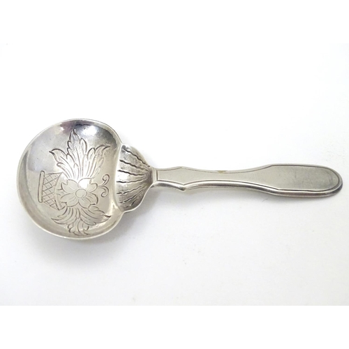 193 - A Portuguese .833 silver tea caddy spoon with engraved decoration and marked Topazio. 3 1/4'' long (... 