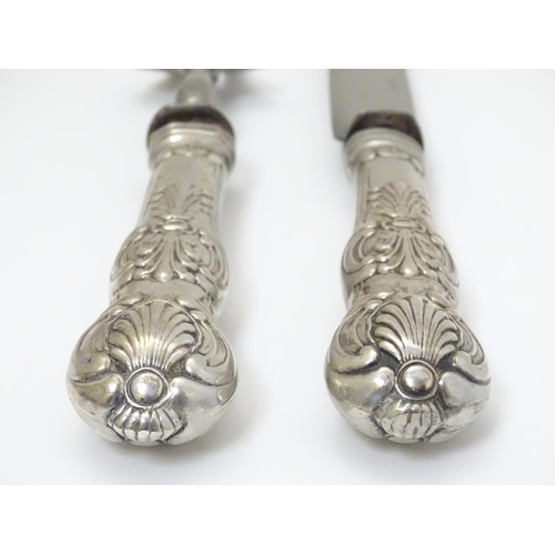 195 - Carving knife and fork with white metal Queens pattern handles. The knife 12 1/2'' long