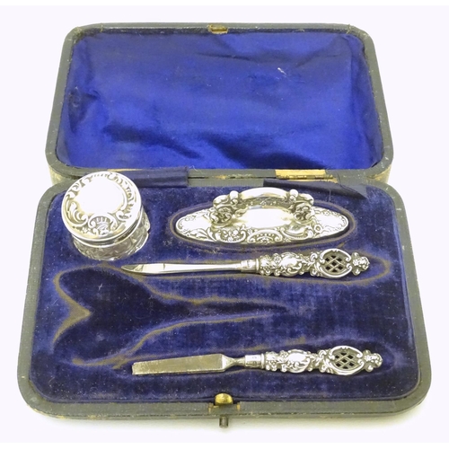 196 - Manicure items comprising silver handled tools, buffer and silver lidded pot. Hallmarked Birmingham ... 