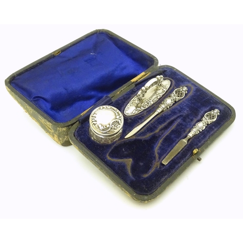 196 - Manicure items comprising silver handled tools, buffer and silver lidded pot. Hallmarked Birmingham ... 