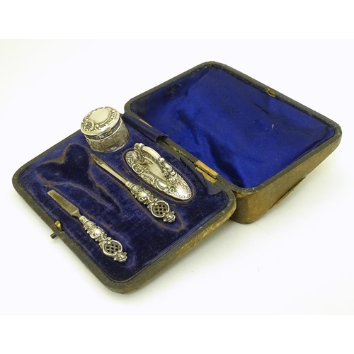 196 - Manicure items comprising silver handled tools, buffer and silver lidded pot. Hallmarked Birmingham ... 