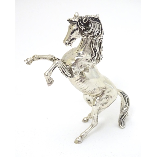 198 - An Egyptian silver model of a horse 4'' long