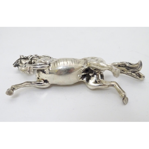 198 - An Egyptian silver model of a horse 4'' long