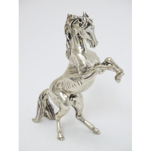 198 - An Egyptian silver model of a horse 4'' long