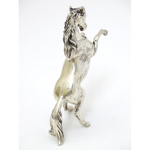 198 - An Egyptian silver model of a horse 4'' long