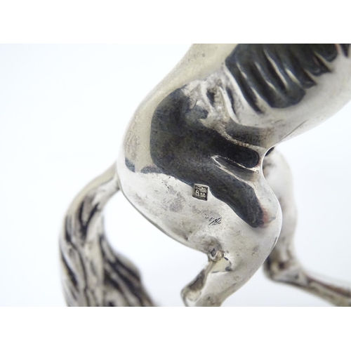 198 - An Egyptian silver model of a horse 4'' long