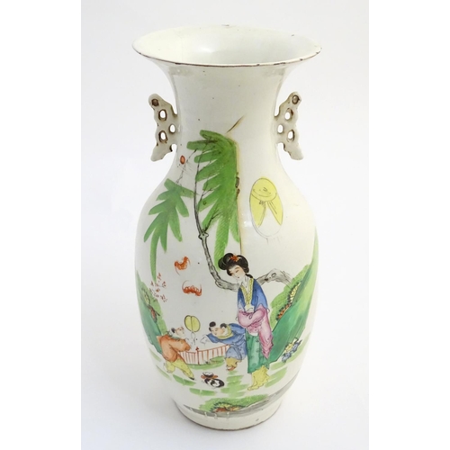 2 - A 20thC Chinese twin handled baluster vase, decorated with figures in a garden with flying lanterns.... 