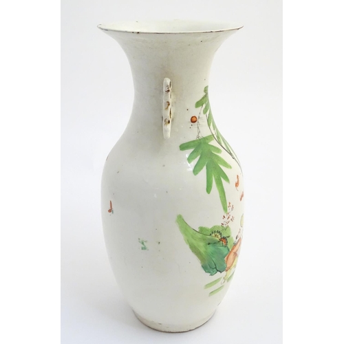 2 - A 20thC Chinese twin handled baluster vase, decorated with figures in a garden with flying lanterns.... 