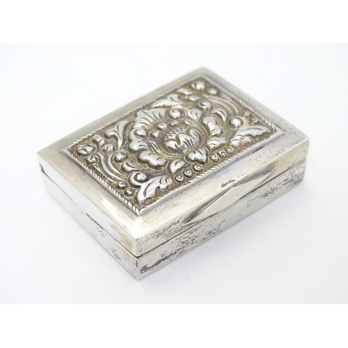 204 - A white metal box of rectangular form with hinged lid.  1 3/4'' x 1 1/4'' x 3/8''