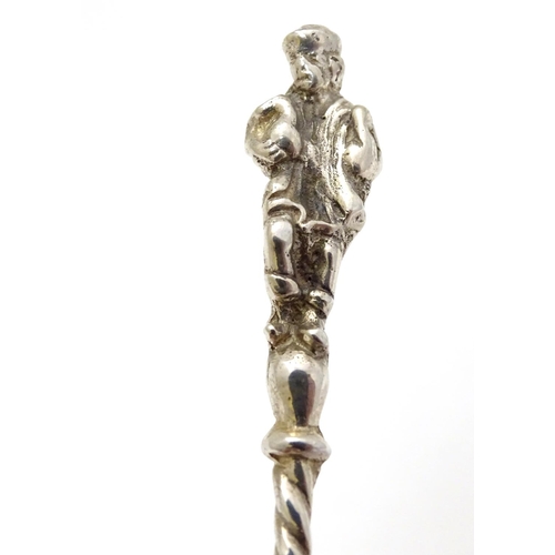 205 - A Continental white metal caddy spoon depicting figures dancing. German . 800 silver 4'' long