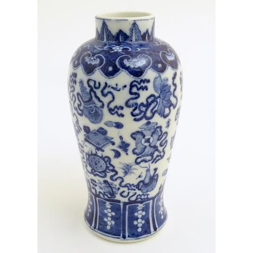 21 - A Chinese blue and white vase decorated with emblems of good fortune, including the chakra (flaming ... 