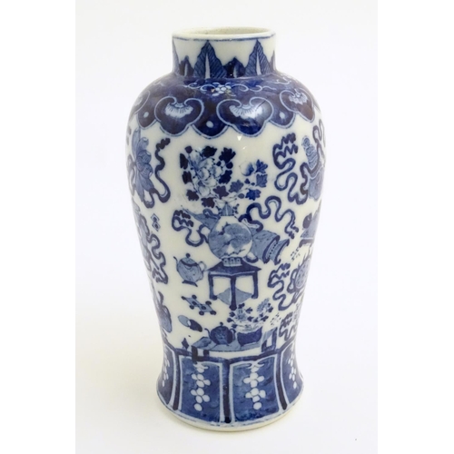 21 - A Chinese blue and white vase decorated with emblems of good fortune, including the chakra (flaming ... 