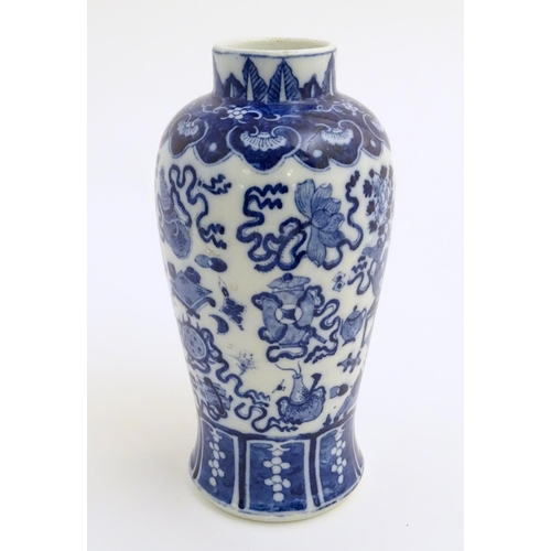 21 - A Chinese blue and white vase decorated with emblems of good fortune, including the chakra (flaming ... 