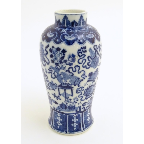 21 - A Chinese blue and white vase decorated with emblems of good fortune, including the chakra (flaming ... 