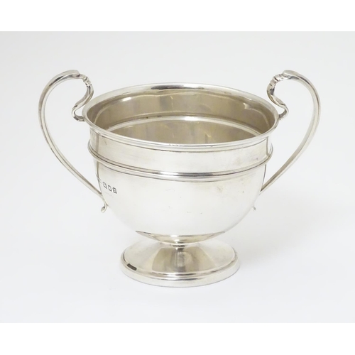 210 - A twin handled trophy cup hallmarked London 1932 maker Sir John Bennett Ltd. (126g)