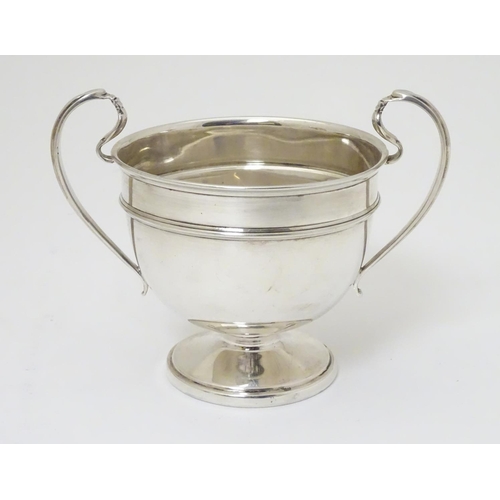 210 - A twin handled trophy cup hallmarked London 1932 maker Sir John Bennett Ltd. (126g)