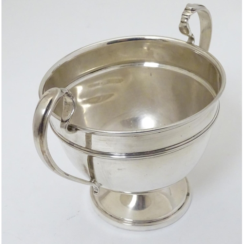 210 - A twin handled trophy cup hallmarked London 1932 maker Sir John Bennett Ltd. (126g)