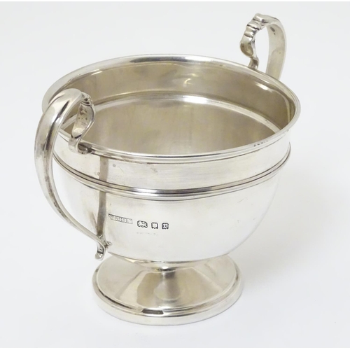 210 - A twin handled trophy cup hallmarked London 1932 maker Sir John Bennett Ltd. (126g)