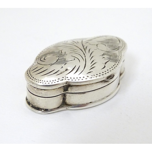 215 - A silver pill box of shaped form with hinged lid and engraved decoration. Marked for Mark Houghton L... 