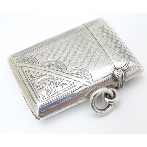 218 - A silver vesta case with engraved decoration. Hallmarked  Birmingham 1902 maker E J Houlston 2'' hig... 