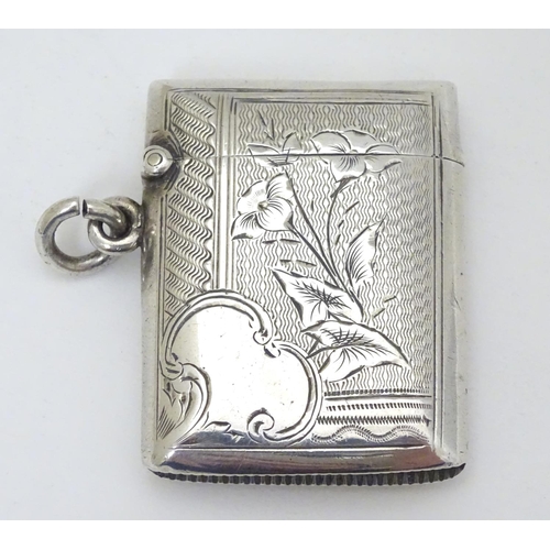 218 - A silver vesta case with engraved decoration. Hallmarked  Birmingham 1902 maker E J Houlston 2'' hig... 