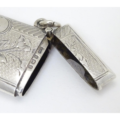 218 - A silver vesta case with engraved decoration. Hallmarked  Birmingham 1902 maker E J Houlston 2'' hig... 