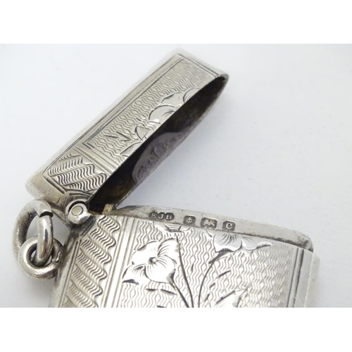 218 - A silver vesta case with engraved decoration. Hallmarked  Birmingham 1902 maker E J Houlston 2'' hig... 