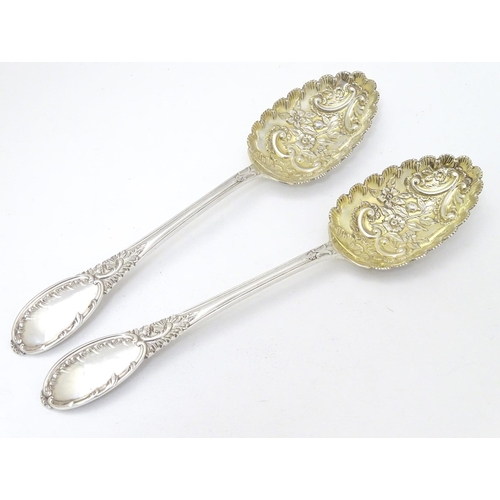 219 - A pair of embossed silver berry spoons hallmarked Sheffield 1906 maker Mappin & Webb Ltd. 9'' long (... 