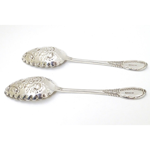 219 - A pair of embossed silver berry spoons hallmarked Sheffield 1906 maker Mappin & Webb Ltd. 9'' long (... 