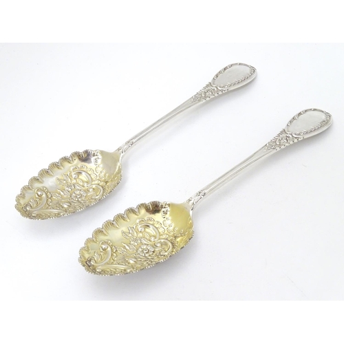 219 - A pair of embossed silver berry spoons hallmarked Sheffield 1906 maker Mappin & Webb Ltd. 9'' long (... 