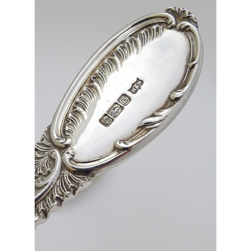 219 - A pair of embossed silver berry spoons hallmarked Sheffield 1906 maker Mappin & Webb Ltd. 9'' long (... 