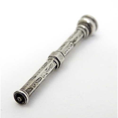 223 - A white metal pencil with amethyst coloured stone to top 2 1/2'' long