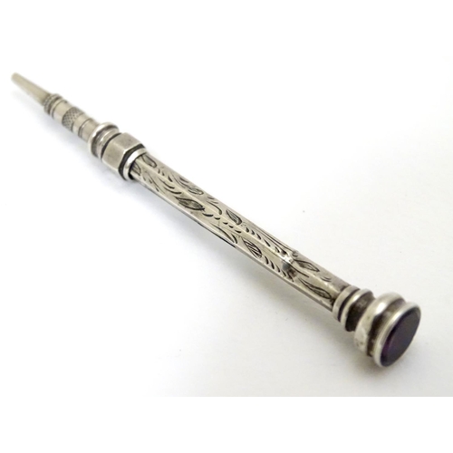 223 - A white metal pencil with amethyst coloured stone to top 2 1/2'' long