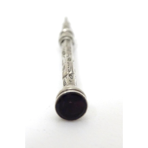 223 - A white metal pencil with amethyst coloured stone to top 2 1/2'' long