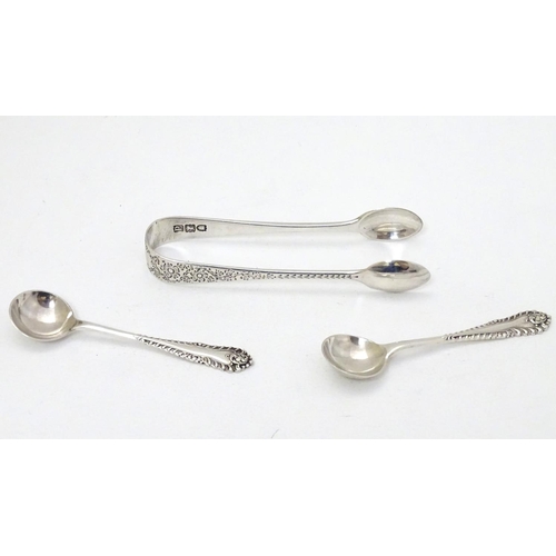 226 - A pair of silver salt spoons hallmarked London 1969 maker Richards & Knight.  Together with sugar to... 