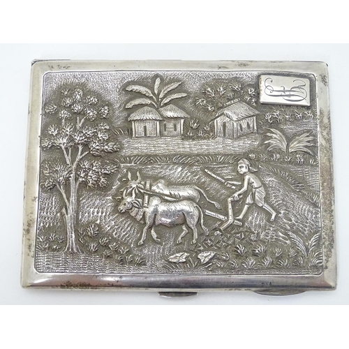 229 - A Sterling silver cigarette case with decoration to lid depicting figure and oxen ploughing the fiel... 