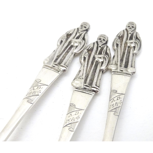 235 - An unusual set of 3 silver apostle spoons the bowls decorated with scenes within a shield cartouche ... 